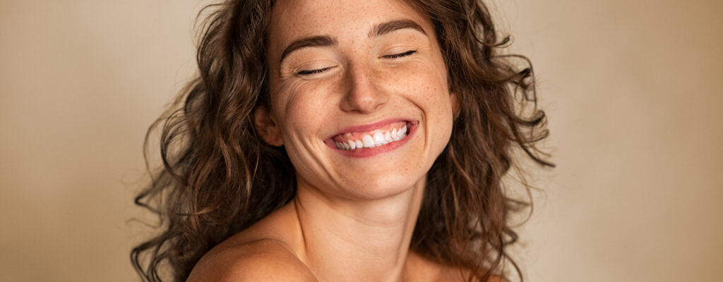Close,Up,Of,Carefree,Young,Woman,Laughing.,Portrait,Of,Smiling